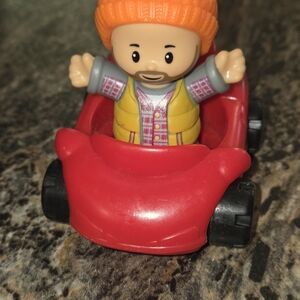 Colorful Action Figure in Red Toy Car